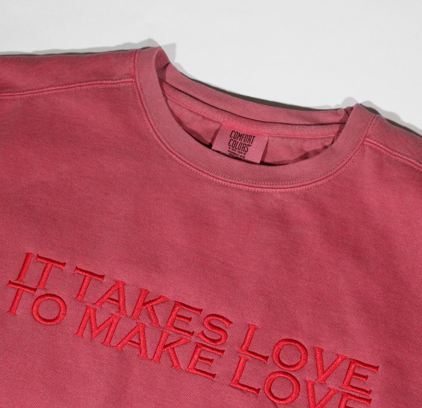 IT TAKES LOVE TO MAKE LOVE PREMIUM PIGMENT CREWNECK - FADED RED